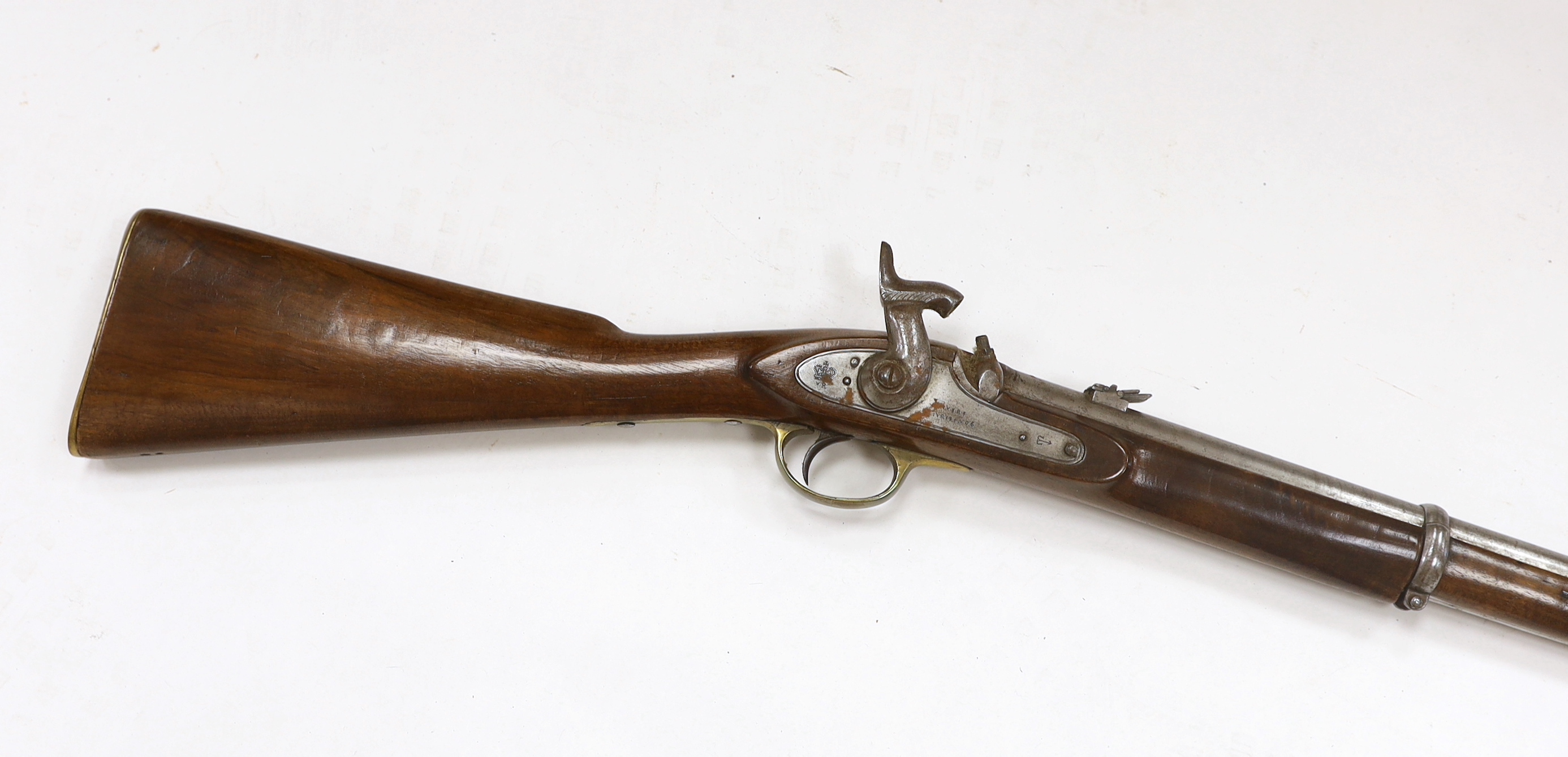 A two band percussion Military carbine of Indian use, regulation brass mounts, fold leaf rear sight, regulation brass mount, lock with Indian marks and also crowned VR, barrel 66.2cm